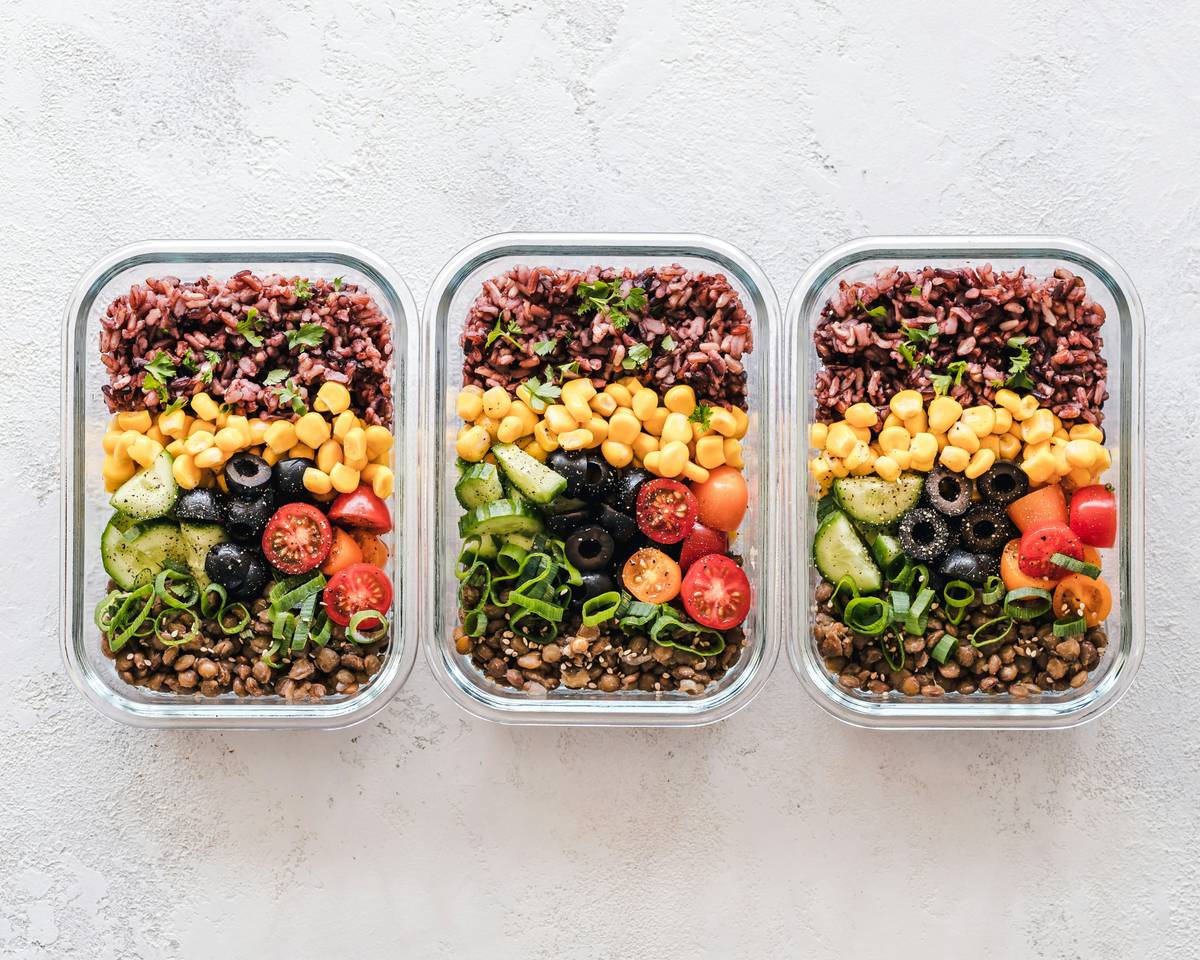 woman preparing a balanced weight loss diet healthy meal with vegetables, lean protein, and whole grains